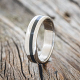 Shown here is "Vertigo", a custom, handcrafted men's wedding ring featuring an offset charred whiskey barrel oak inlay, upright facing left. Additional inlay options are available upon request.