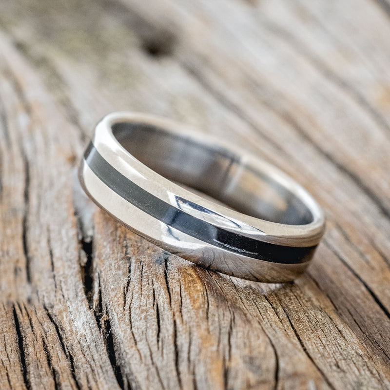 Shown here is "Vertigo", a custom, handcrafted men's wedding ring featuring an offset charred whiskey barrel oak inlay, tilted left. Additional inlay options are available upon request.