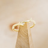 Shown here is The "Artemis", a stacking ring with an antler/branch style band with a single diamond accent.