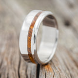 Shown here is "Vertigo", a handcrafted men's wedding ring featuring an offset ironwood inlay, upright facing left. Additional inlay options are available upon request.
