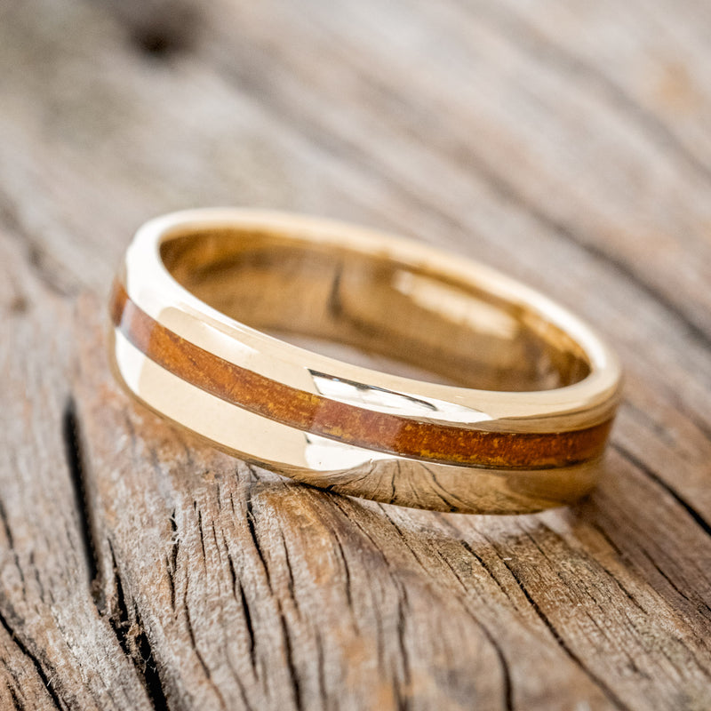 Shown here is "Vertigo" a handcrafted men's wedding ring featuring an offset ironwood inlay, tilted left. 