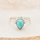 Shown here is "Shania", a turquoise women's engagement ring with diamond accents, front facing. Many other center stone options are available upon request.