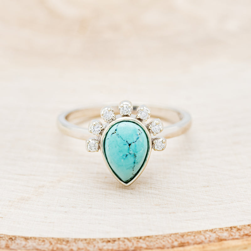 Shown here is "Shania", a turquoise women's engagement ring with diamond accents, front facing. Many other center stone options are available upon request.