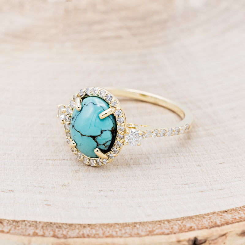 Shown here is "KB", a halo-style oval turquoise women's engagement ring with diamond accents, facing left. Many other center stone options are available upon request.