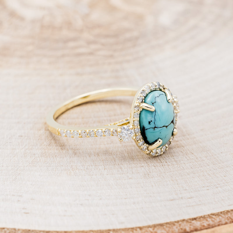 Shown here is "KB", a halo-style oval turquoise women's engagement ring with diamond accents, facing right. Many other center stone options are available upon request.