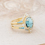 Shown here is "KB", a halo-style oval turquoise women's engagement ring with diamond accents and "Sama" tracers, facing right. Many other center stone options are available upon request.