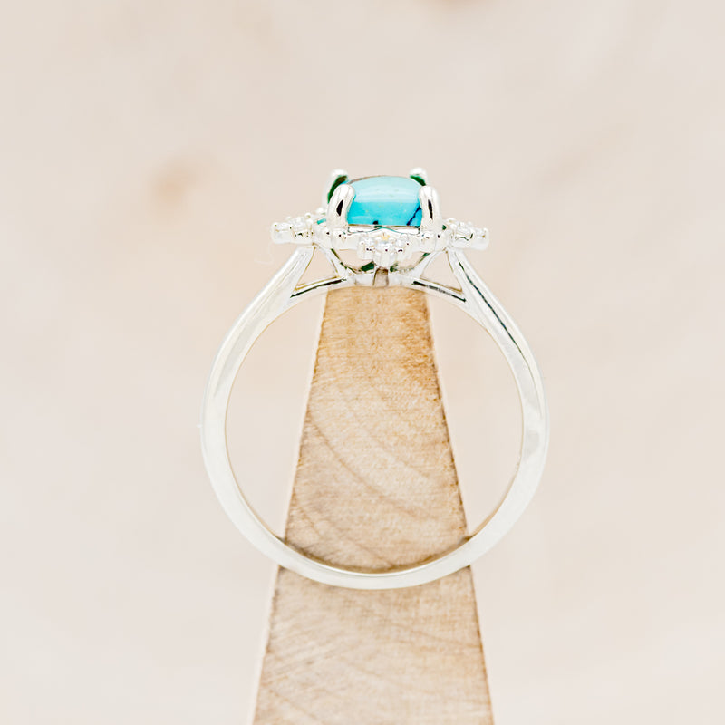Shown here is "Treva", a turquoise women's engagement ring with diamond accents, side view on stand. Many other center stone options are available upon request.