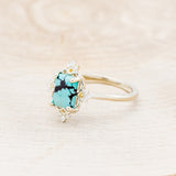 Shown here is "Treva", a turquoise women's engagement ring with diamond accents, facing left. Many other center stone options are available upon request.