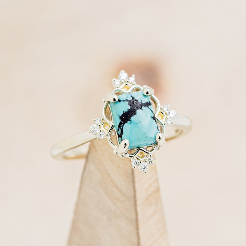 Shown here is "Treva", a turquoise women's engagement ring with diamond accents, on stand front facing. Many other center stone options are available upon request. 