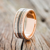 Shown here is "Rio", a custom, handcrafted men's wedding ring featuring 3 channels with elk antler and iron ore inlays, upright facing left. Additional inlay options are available upon request.