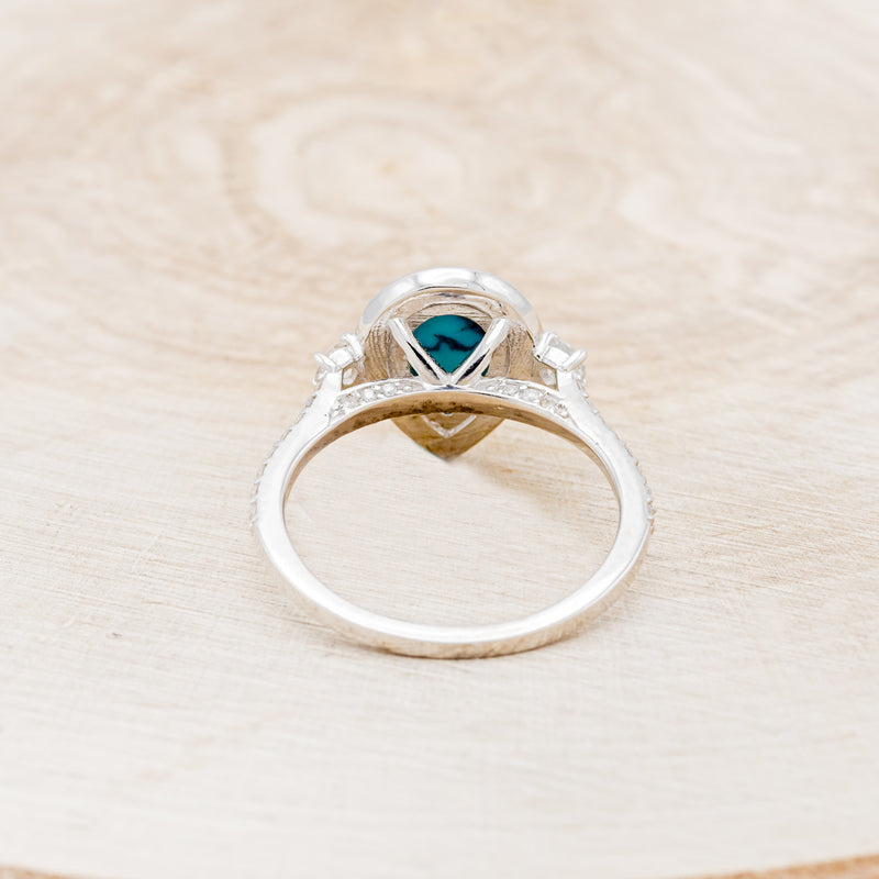 Shown here is "KB", a turquoise women's engagement ring with a diamond halo and diamond accents, back view. Many other center stone options are available upon request.