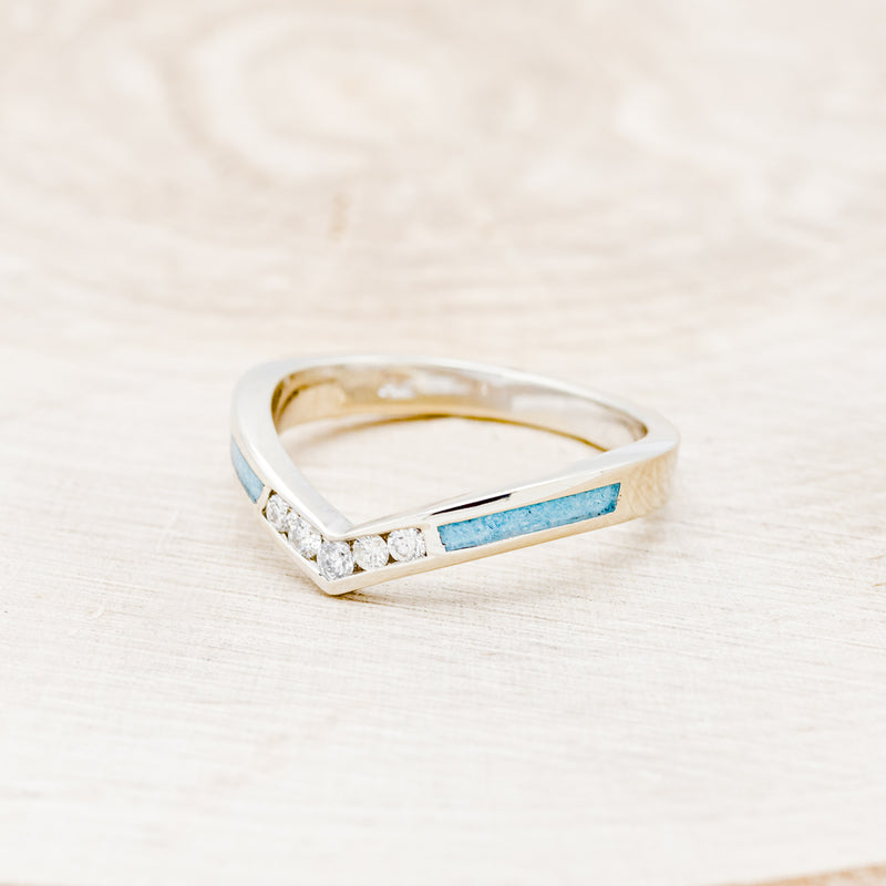 Shown here is "Kida", a custom, handcrafted women's stacking band featuring turquoise inlays and diamonds on a 14K gold band, facing left. Additional inlay options are available upon request.