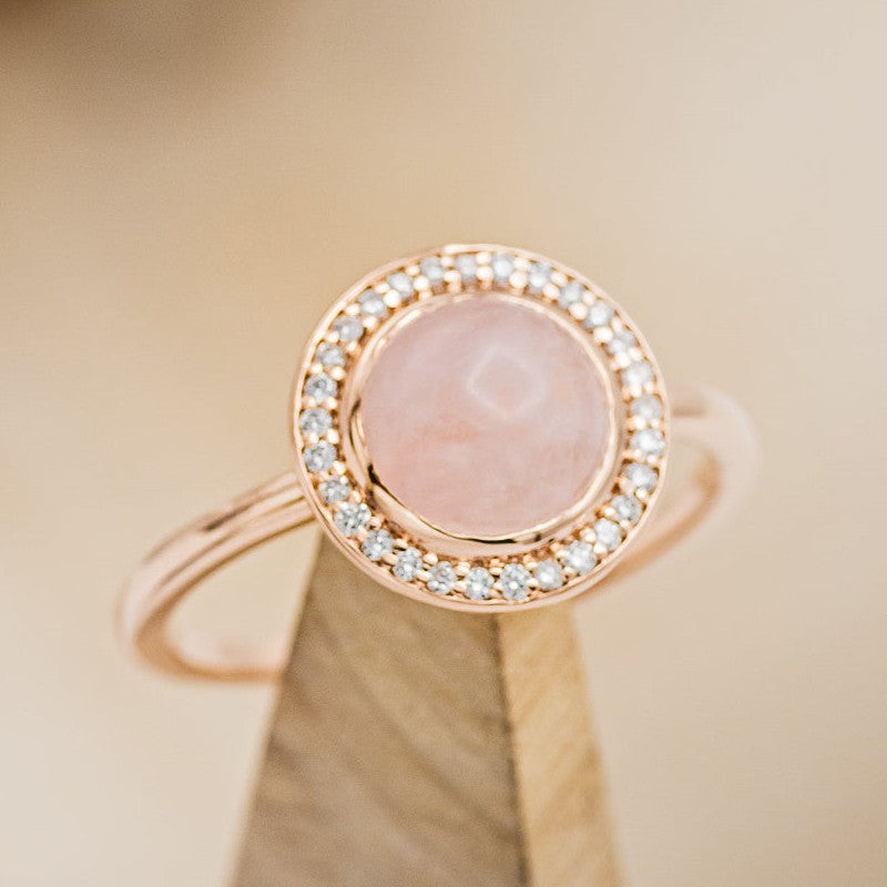 Shown here is The "Terra", a rose quartz women's engagement ring with a diamond halo