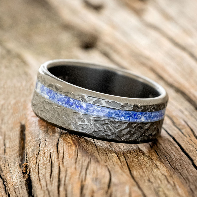 Shown here is "Vertigo", a custom, handcrafted men's wedding ring featuring a lapis lazuli inlay with a crosshatched finish, tilted left. Additional inlay options are available upon request.