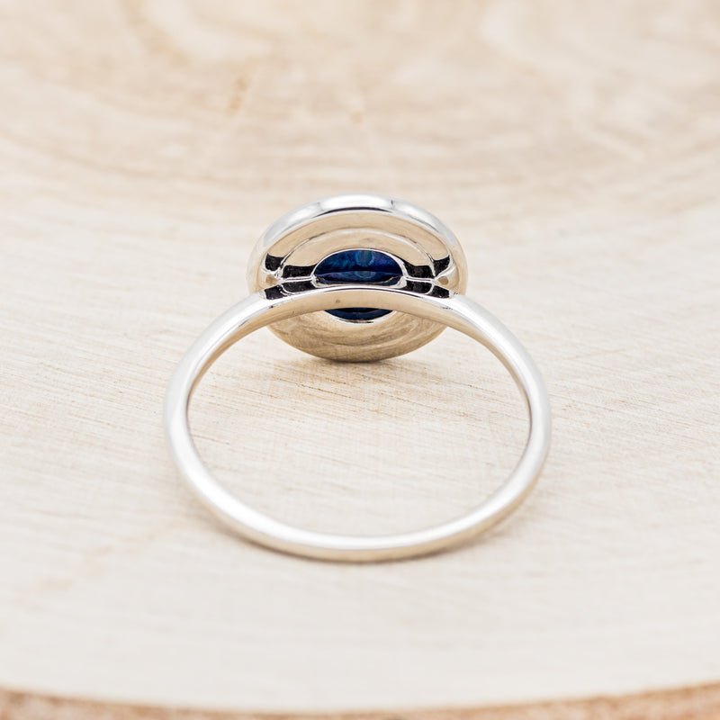 Shown here is "Terra", a round paua shell women's engagement ring with a diamond halo, back view. Many other center stone options are available upon request.
