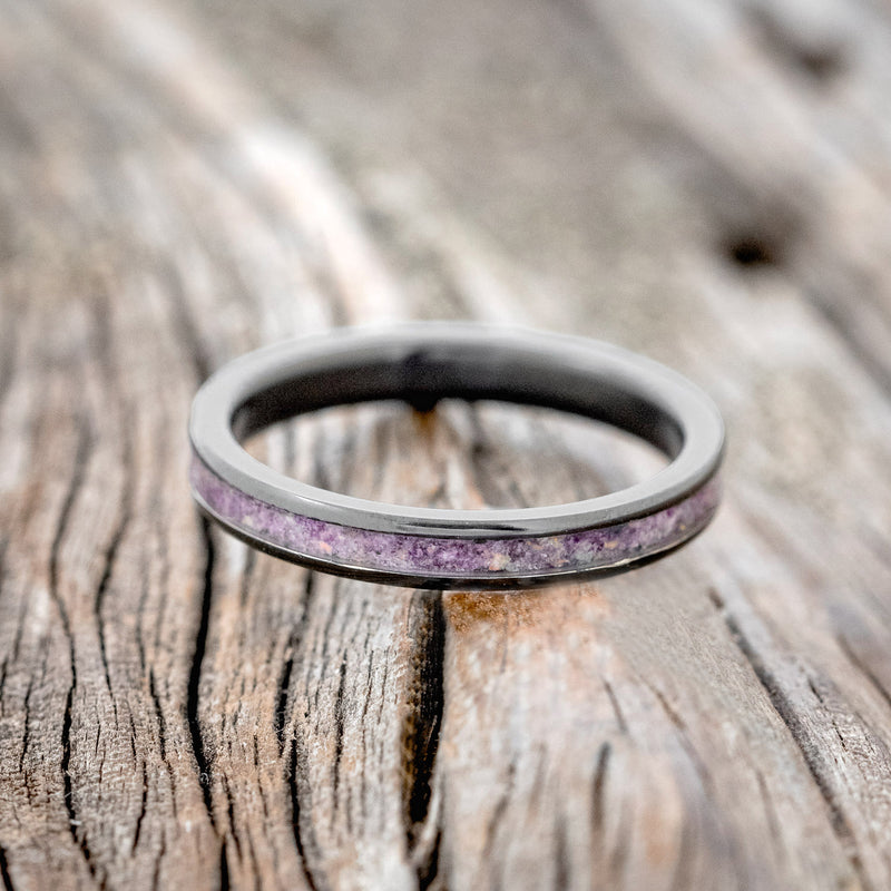 Shown here is "Eterna", a custom, handcrafted women's stacking band featuring a sugilite inlay mixed with fire & ice opal, laying flat. Additional inlay options are available upon request.