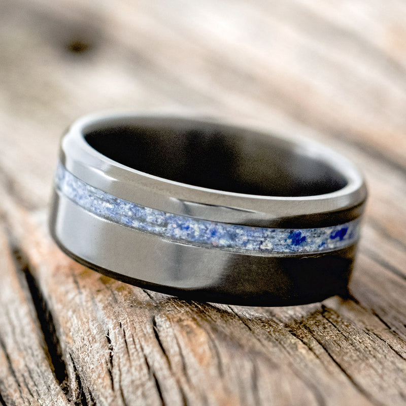 Shown here is "Vertigo", a custom, handcrafted men's wedding ring featuring a beautiful mixture of lapis lazuli & fire and ice opal inlay, tilted left. Additional inlay options are available upon request.