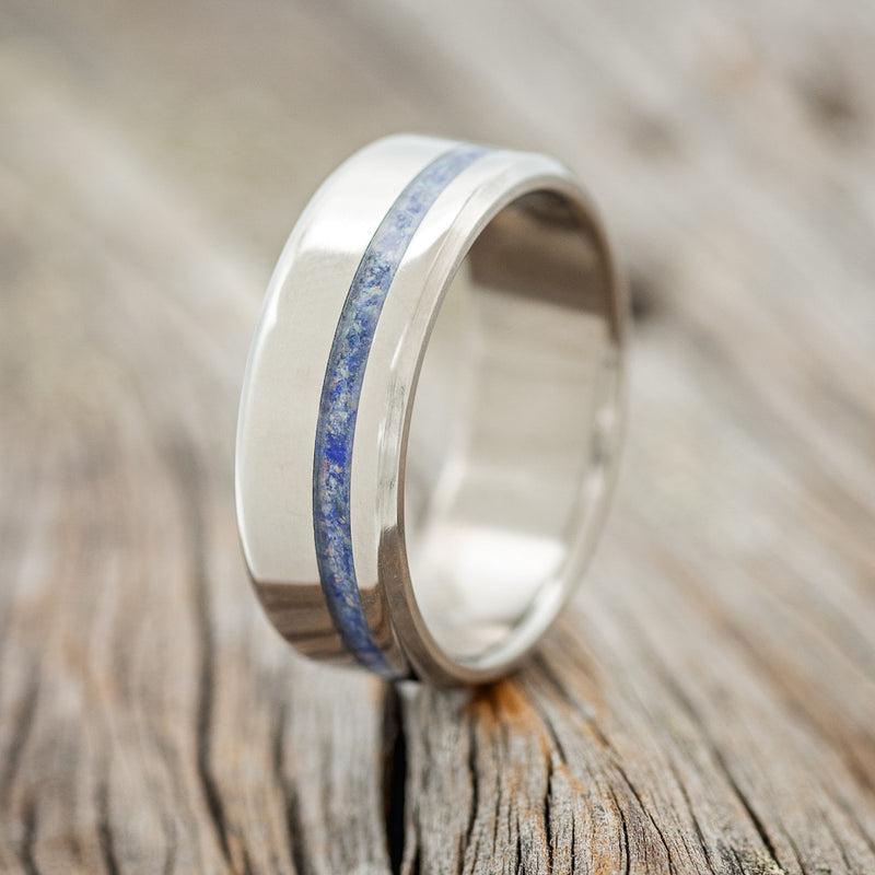 Shown here is "Vertigo", a handcrafted men's wedding ring shown featuring an offset mix of lapis lazuli and fire & ice opal inlay, upright facing left.