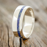 Shown here is "Vertigo", a custom, handcrafted men's wedding ring featuring a beautiful mixture of lapis lazuli & fire and ice opal inlay, upright facing left. Additional inlay options are available upon request.