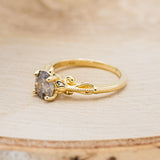 Shown here is "Rosemary", a vintage-style women's engagement ring with sculptural-inspired band displayed here with a round salt and pepper diamond but listed here as a mounting-only option, facing left. Follow the instructions above to select your stone.