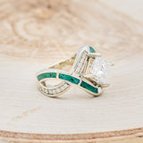 Shown here is "Helix", a geometric-style princess cut moissanite women's engagement ring with diamond accents and malachite inlays, facing right. Many other center stone options are available upon request.