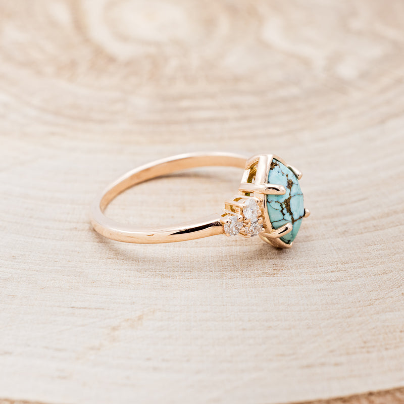 Shown here is "Raya", a turquoise women's engagement ring with diamond accents, facing right. Many other center stone options are available upon request.