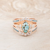 Shown here is "Raya", a turquoise women's engagement ring with diamond accents and a ring guard, front facing. Many other center stone options are available upon request.