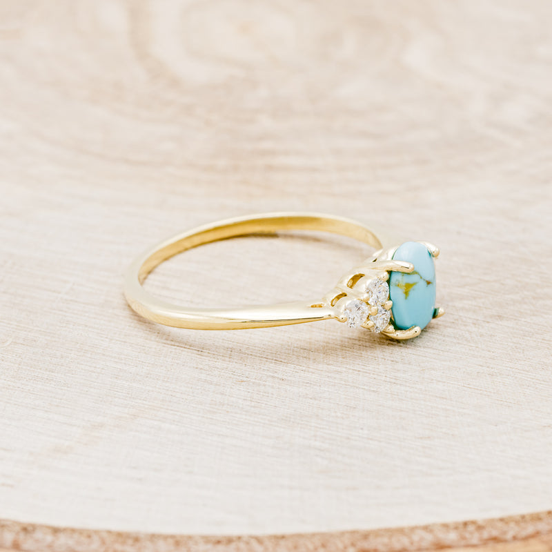 Shown here is "Rhea", a turquoise women's engagement ring with diamond accents, facing right. Many other center stone options are available upon request.