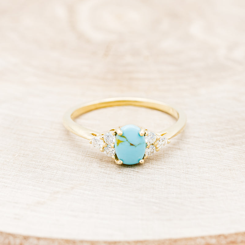 Shown here is "Rhea", a turquoise women's engagement ring with diamond accents, front facing. Many other center stone options are available upon request.