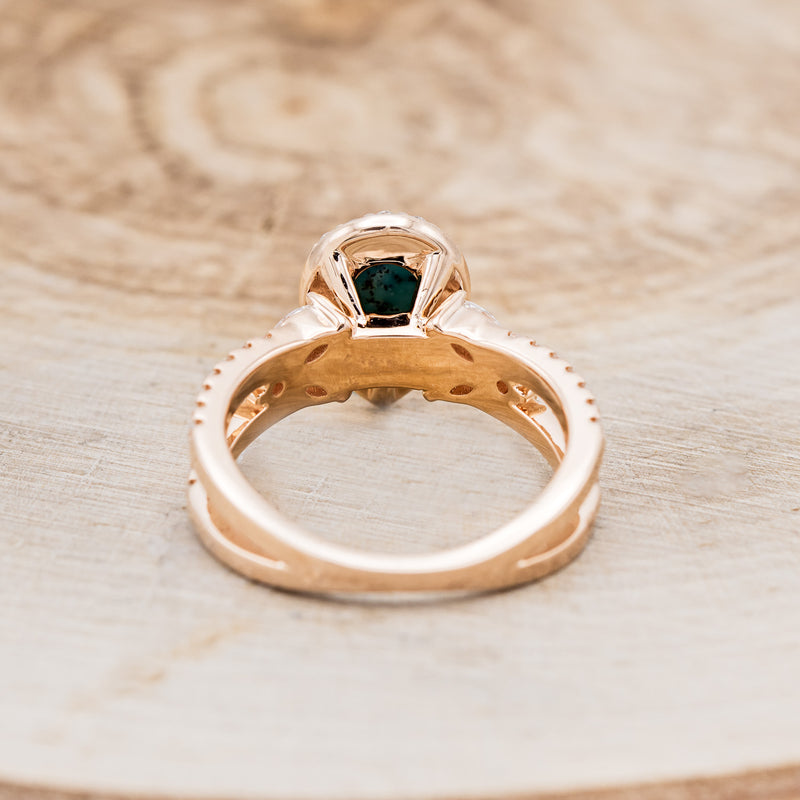 Shown here is "Loretta", a split shank-style turquoise women's engagement ring with a diamond halo and leaf-shape diamond accents, back view. Many other center stone options are available upon request.
