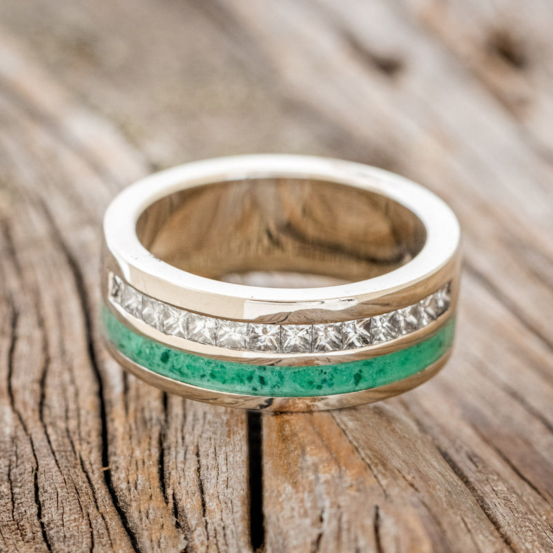 Shown here is "Memphis", a custom, handcrafted men's wedding ring featuring a malachite inlay and princess cut diamond accents, laying flat. Additional inlay options are available upon request.