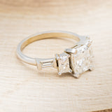 "GRETA" - EMERALD CUT MOISSANITE ENGAGEMENT RING WITH DIAMOND ACCENTS & TURQUOISE TRACER
