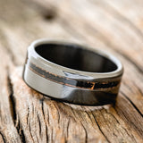  Shown here is "Vertigo", a custom, handcrafted men's wedding ring featuring a patina copper inlay, tilted left. Additional inlay options are available upon request.