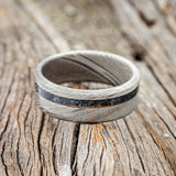 Shown here is "Vertigo", a custom, handcrafted men's wedding ring featuring a patina copper inlay, laying flat. Additional inlay options are available upon request.