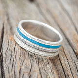 Shown here is "Cosmo", a custom, handcrafted men's wedding ring featuring elk antler and hand-crushed turquoise offset into two channels on a hammered band, titled left. Additional inlay options are available upon request.