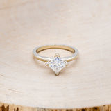 Shown here is a solitaire-style moissanite women's engagement ring, front facing. Many other center stone option are available upon request.