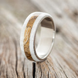 Shown here is "Canyon", a custom, handcrafted men's ring featuring a spalted maple inlay set between two antler overlays, upright facing left. Additional inlay options are available upon request.