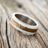Shown here is "Canyon", a custom, handcrafted men's ring featuring a spalted maple inlay set between two antler overlays, tilted left. Additional inlay options are available upon request.