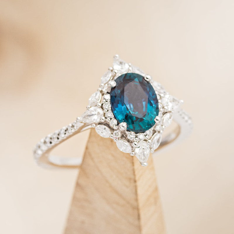 shown here is The "North Star", a halo-style oval lab-created alexandrite women's engagement ring with delicate and ornate details and is available with many center stone options.Alexandrite Engagement Ring - Staghead Designs