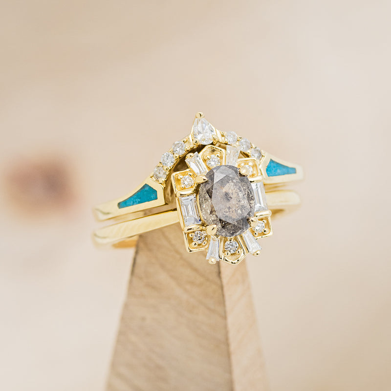 Shown here is  The "Cleopatra", an art deco-style oval salt & pepper diamond women's engagement ring with diamond accents and a turquoise tracer.