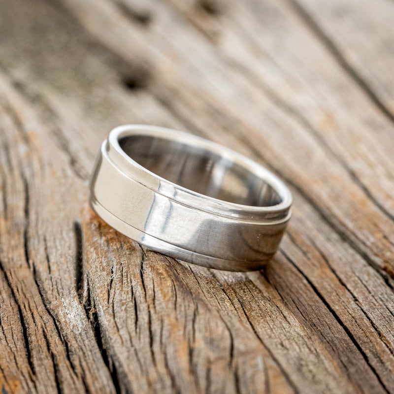 Shown here is "Sedona", a custom, handcrafted men's wedding ring featuring a solid metal band with a raised center, tilted left. Additional inlay options are available upon request.