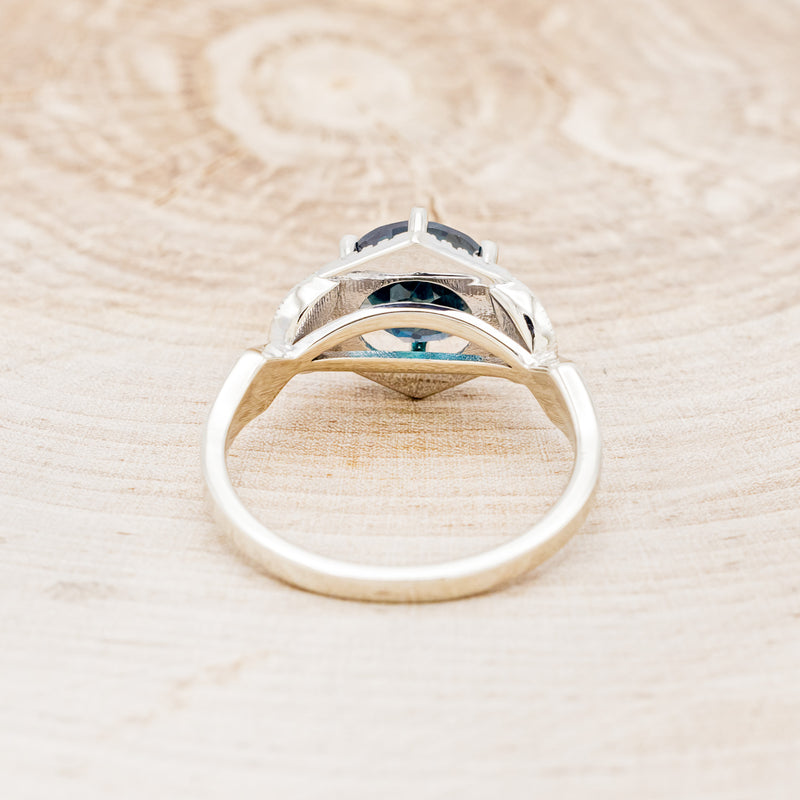 Shown here is "Lucy in the Sky", a halo-style lab-created alexandrite women's engagement ring with diamond accents and turquoise inlays, back view. Many other center stone options are available upon request.
