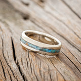 Shown here is "Nirvana", a custom, handcrafted men's wedding ring featuring a centered patina copper inlay, tilted left. Additional inlay options are available upon request.