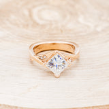 Shown here is "Lina", a moissanite women's engagement ring with diamond accents, front facing. Many other center stone options are available upon request