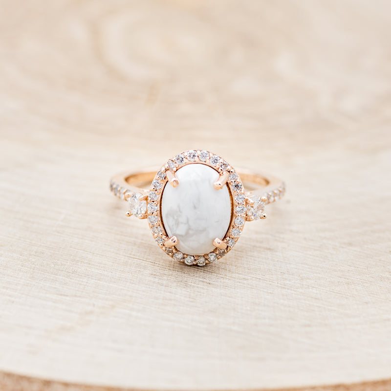 Shown here is "KB", an oval white buffalo turquoise women's engagement ring with a diamond halo and diamond accents, front facing. Many other center stone options are available upon request.