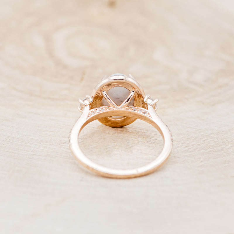 Shown here is "KB", an oval white buffalo turquoise women's engagement ring with a diamond halo and diamond accents, back view. Many other center stone options are available upon request.
