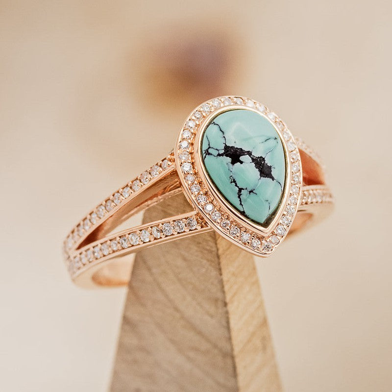 Shown here is A split shank-style turquoise women's engagement ring with delicate and ornate details and is available with many center stone options. -Teardrop Turquoise Engagement Ring with Diamond Halo - Staghead Designs