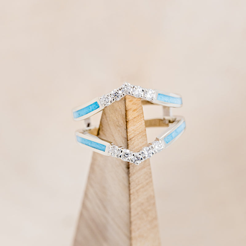 Shown here is "Raya", ring guard, a custom, handcrafted ring featuring turquoise inlays and diamond accents, on stand front facing.