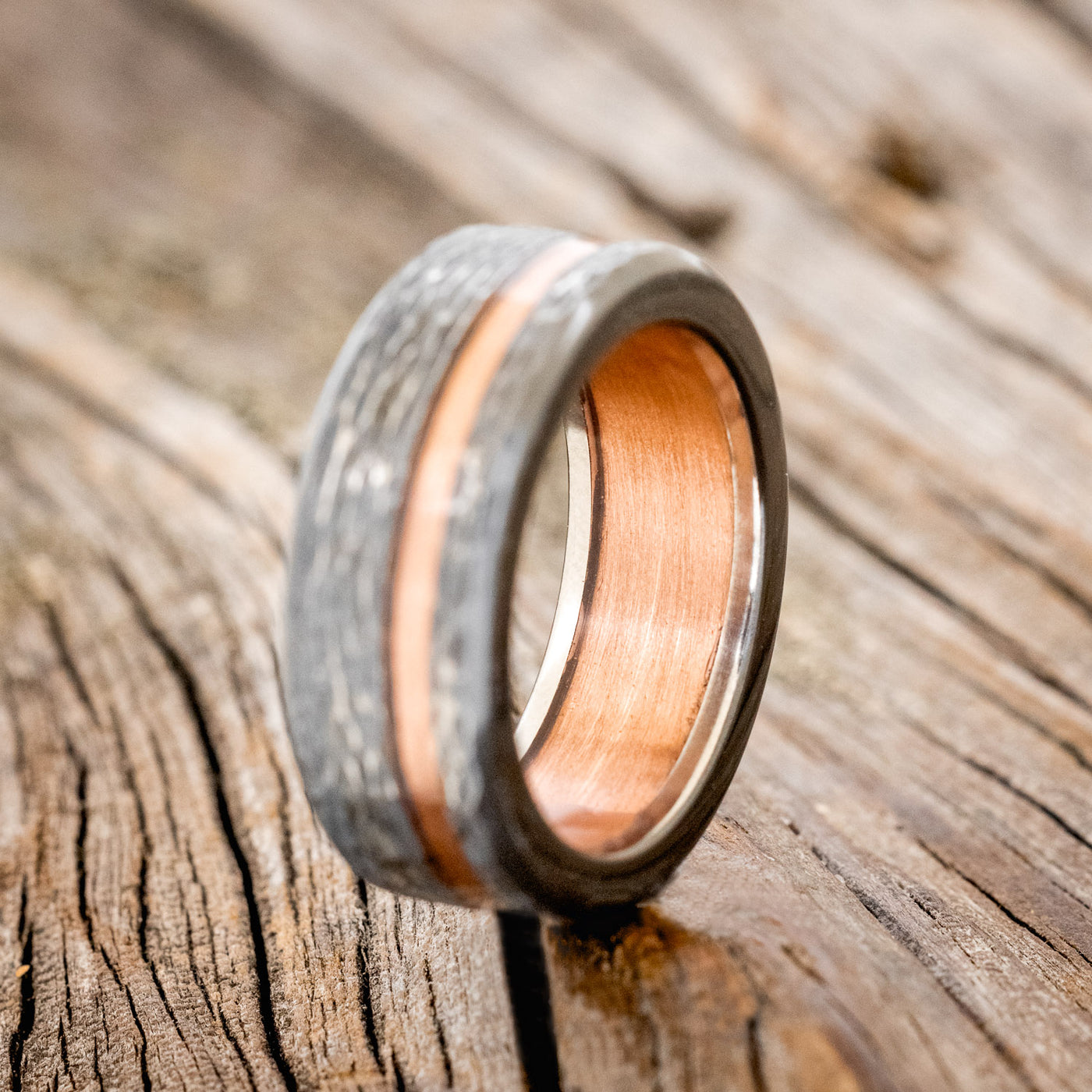 vertigo rustic copper wedding ring featuring a copper lining hammered black zirconium band