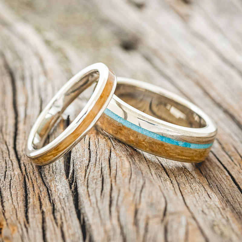 Shown here is a matching wedding band set featuring "Eterna" & "Ezra", laying together. "Ezra" is a handcrafted wedding band featuring a whiskey barrel overlay with a turquoise inlay. "Eterna" is a stacking-style wedding band featuring a whiskey barrel oak inlay. Here, both rings are shown here in 14K white gold bands. Additional inlay options are available upon request!